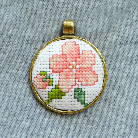 Elegant vintage looking embroidered floral pendant with pink sakura flower